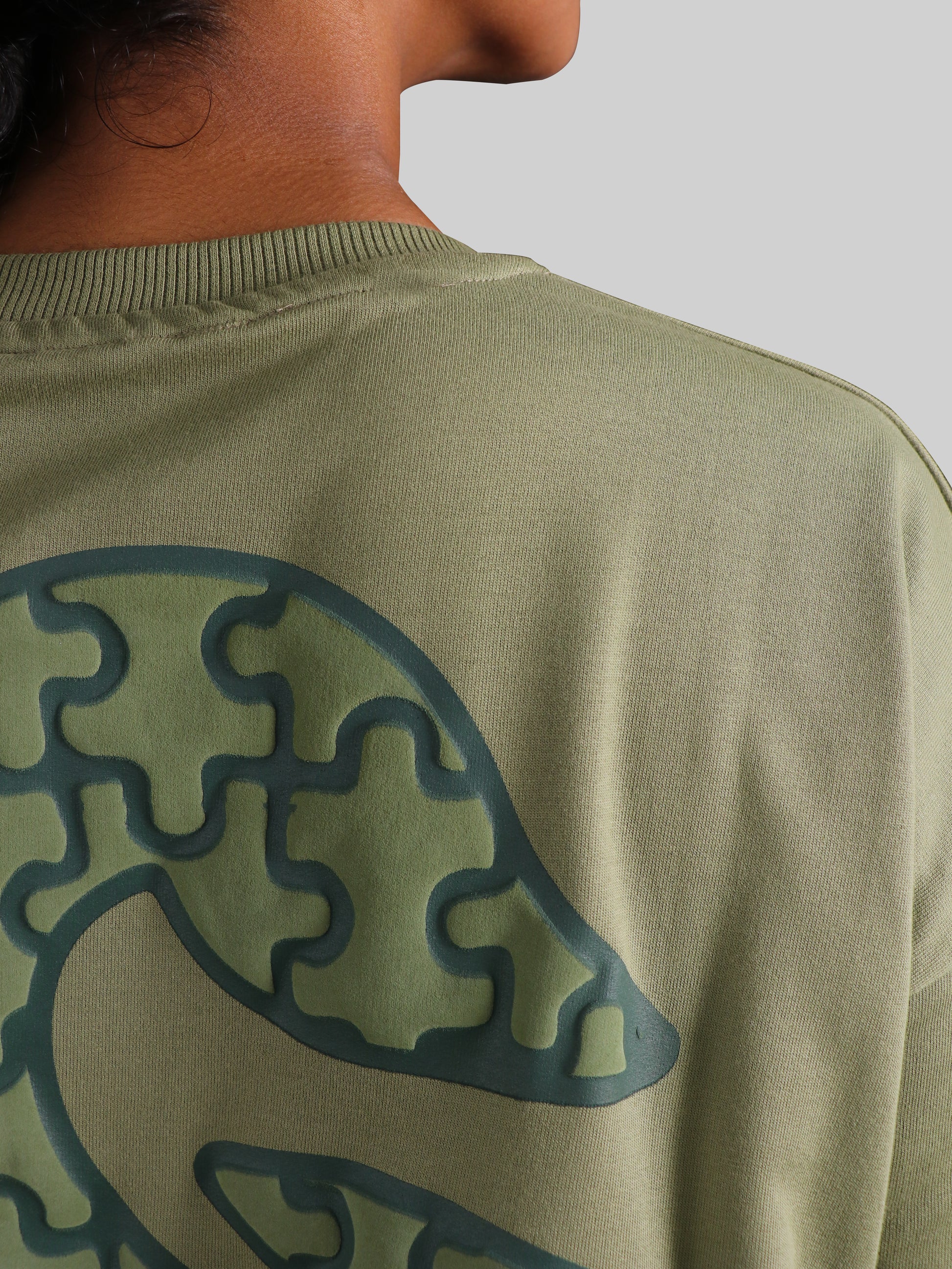 Unisex olive green graphic tee abstract puzzle print modern streetwear style