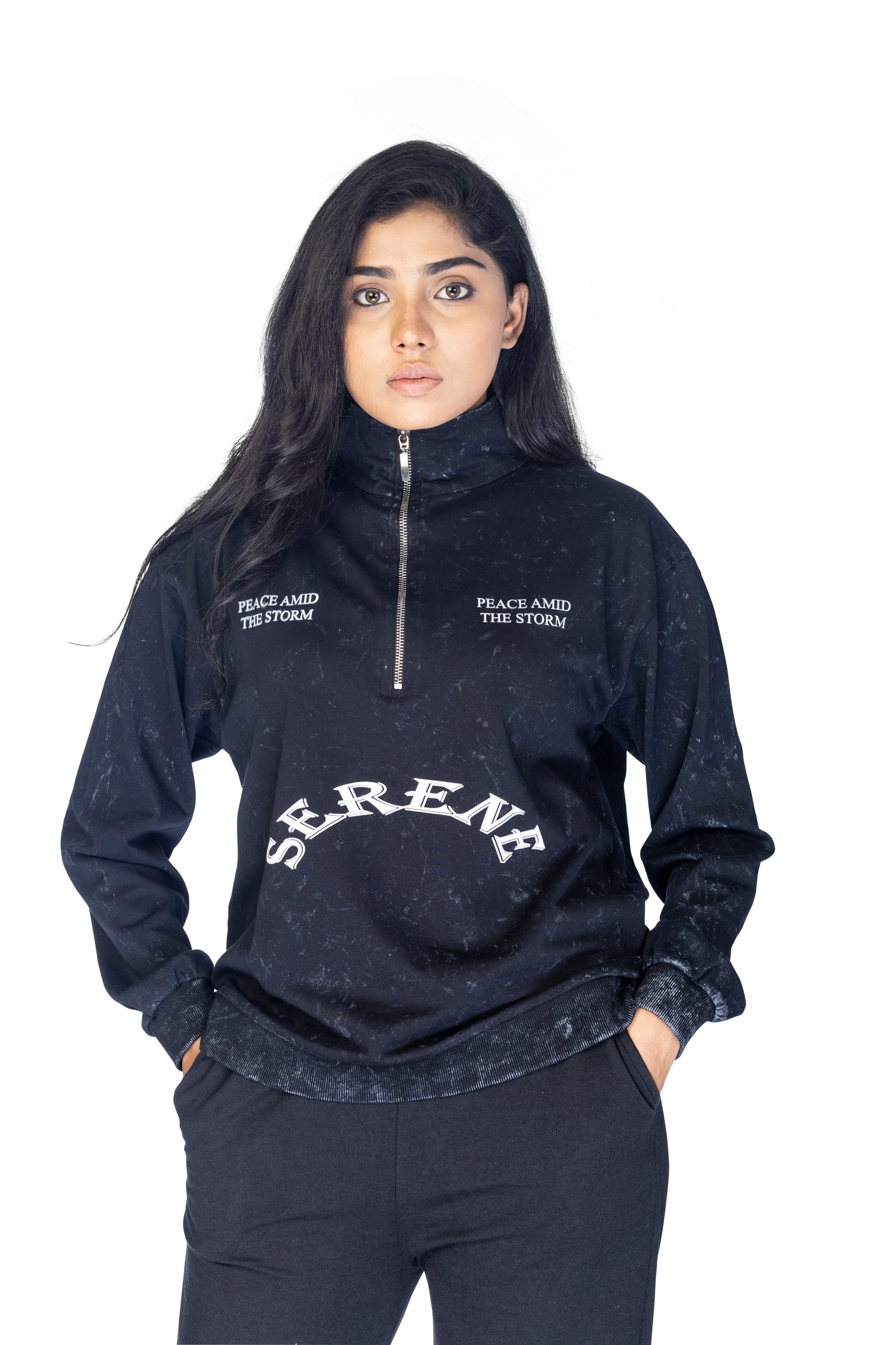 Person wearing a black hoodie with 'Serenity' text on a white background