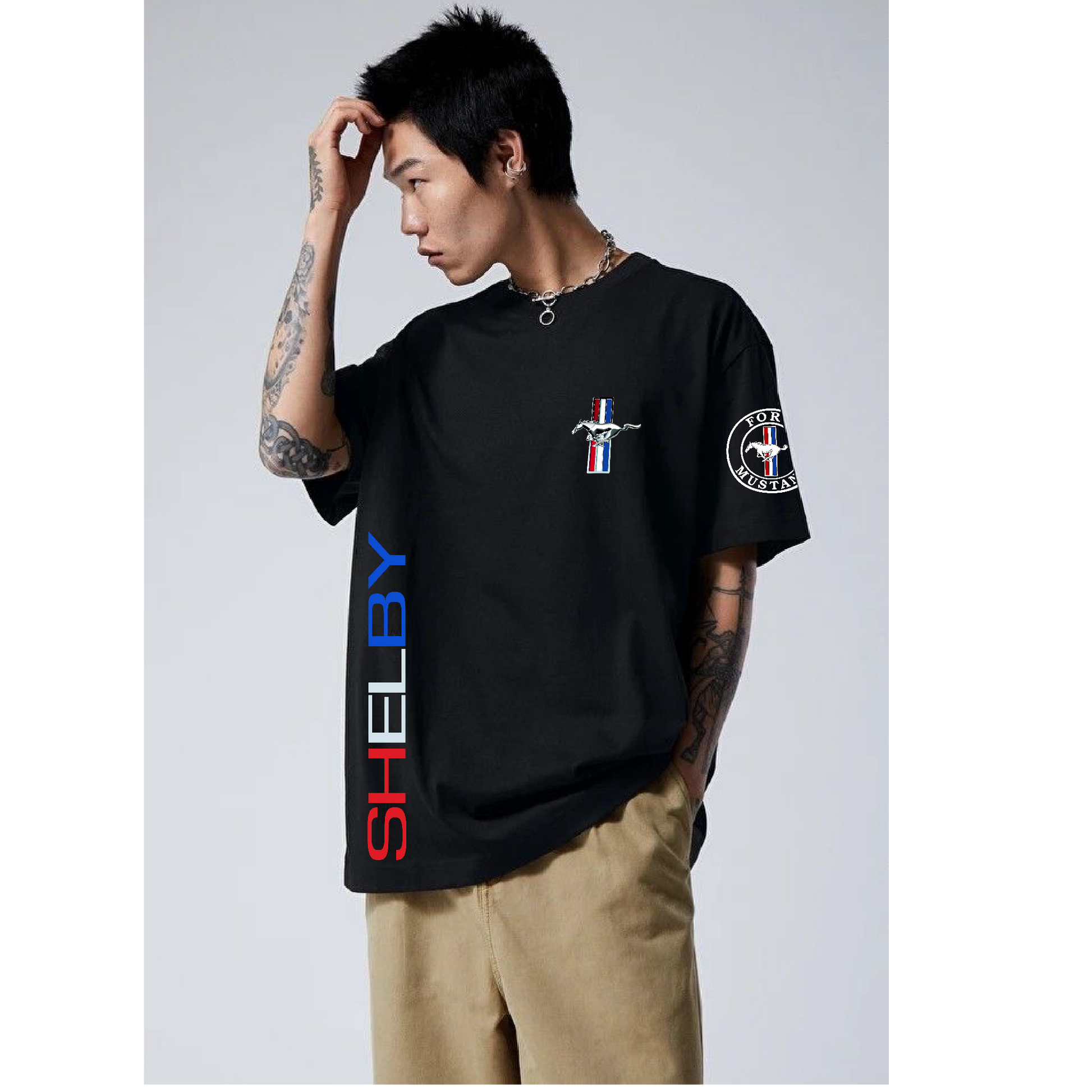 Person wearing a black t-shirt with 'Shelby' branding on a gray background