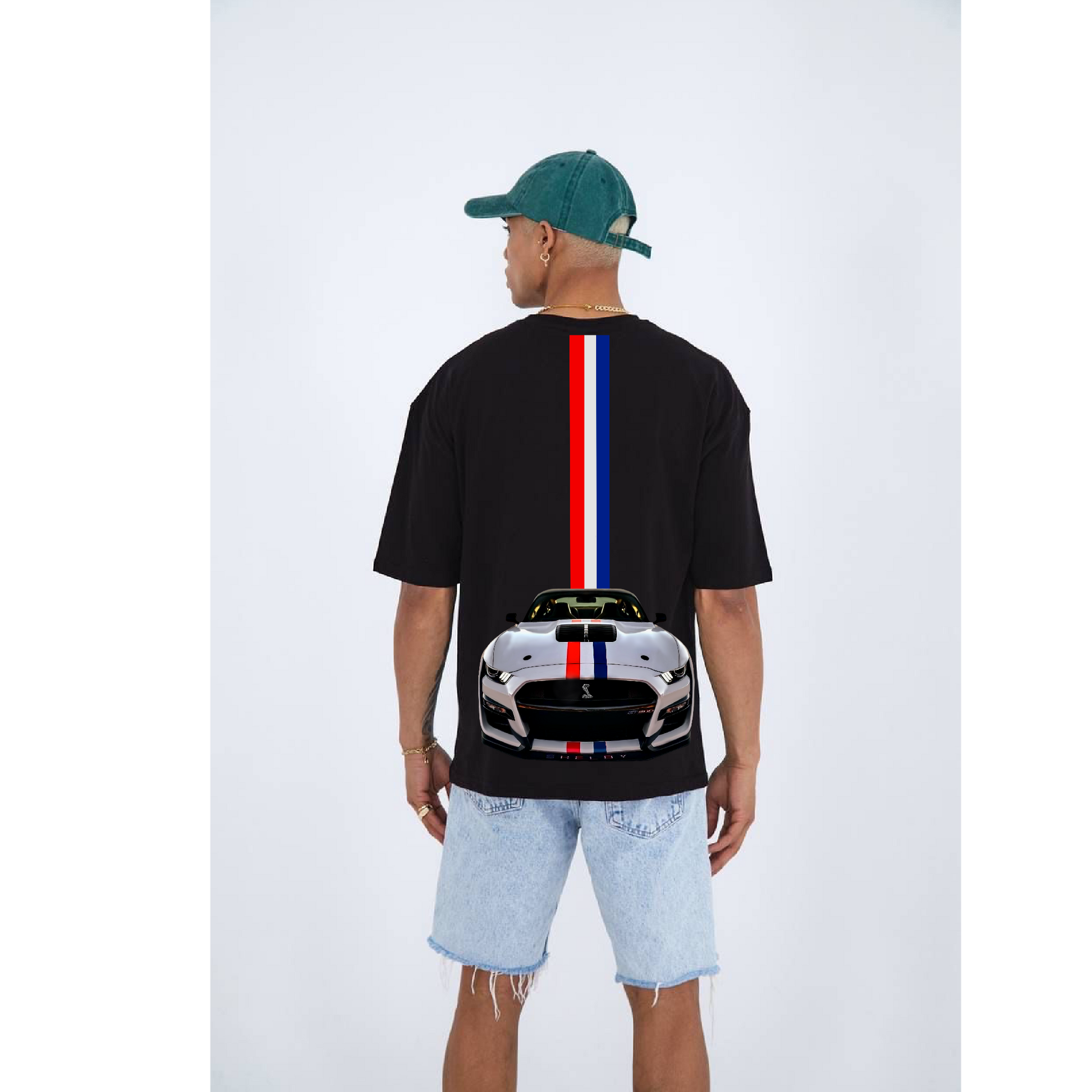 Person wearing a black t-shirt with a car design on the back, standing against a white background