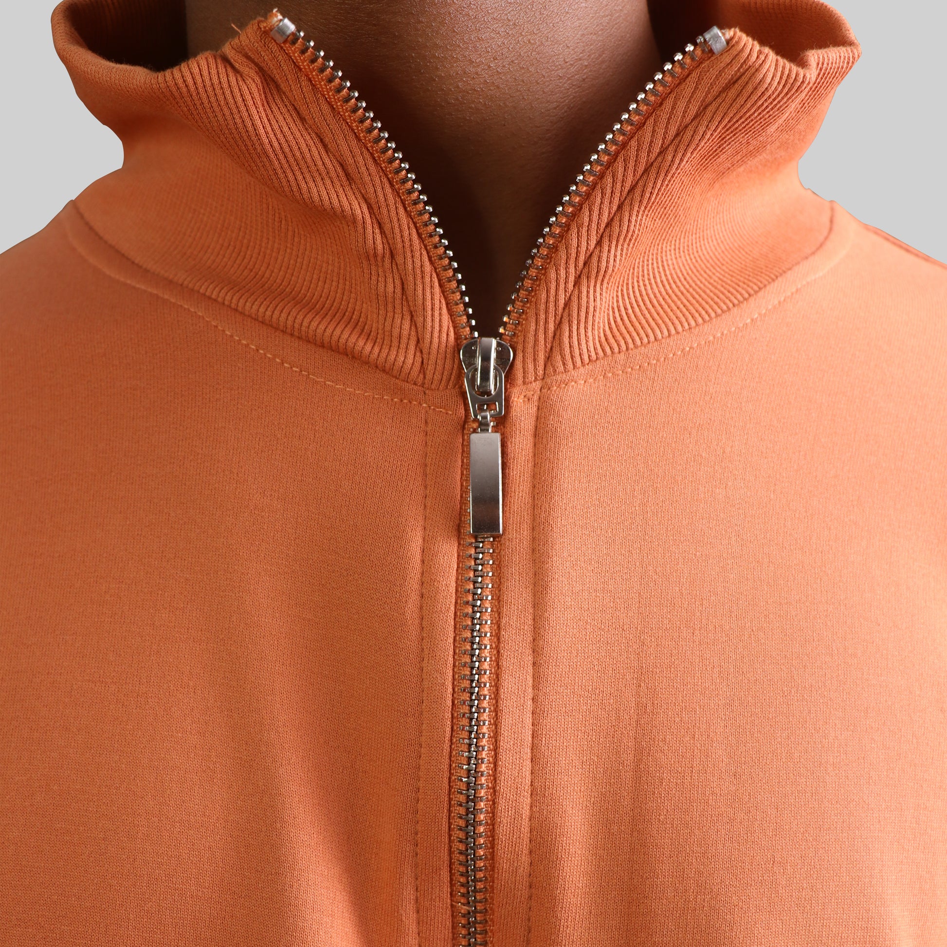 Brown and beige jacket with geometric pattern on a gray background