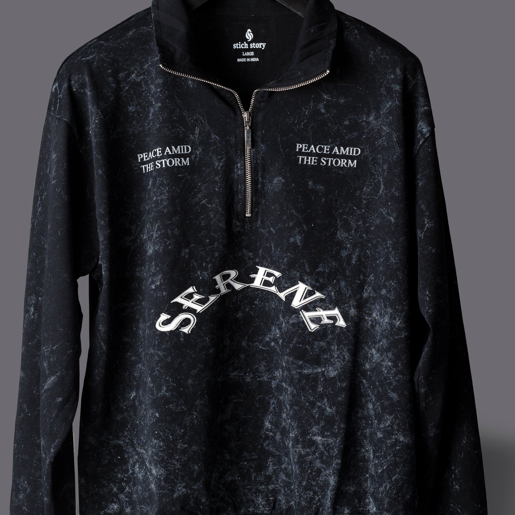 Black pullover with text on a gray background