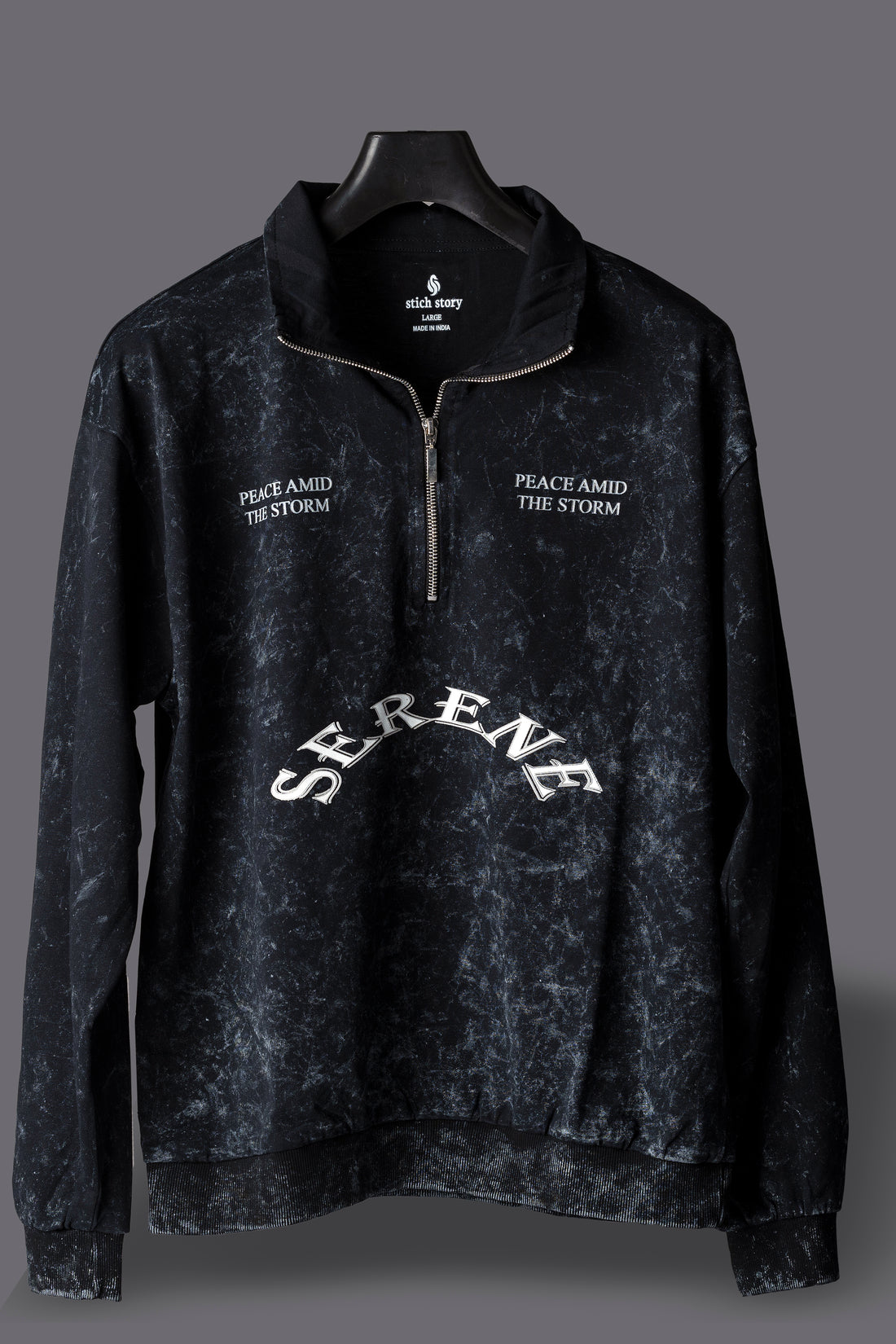 Black pullover with text on a gray background