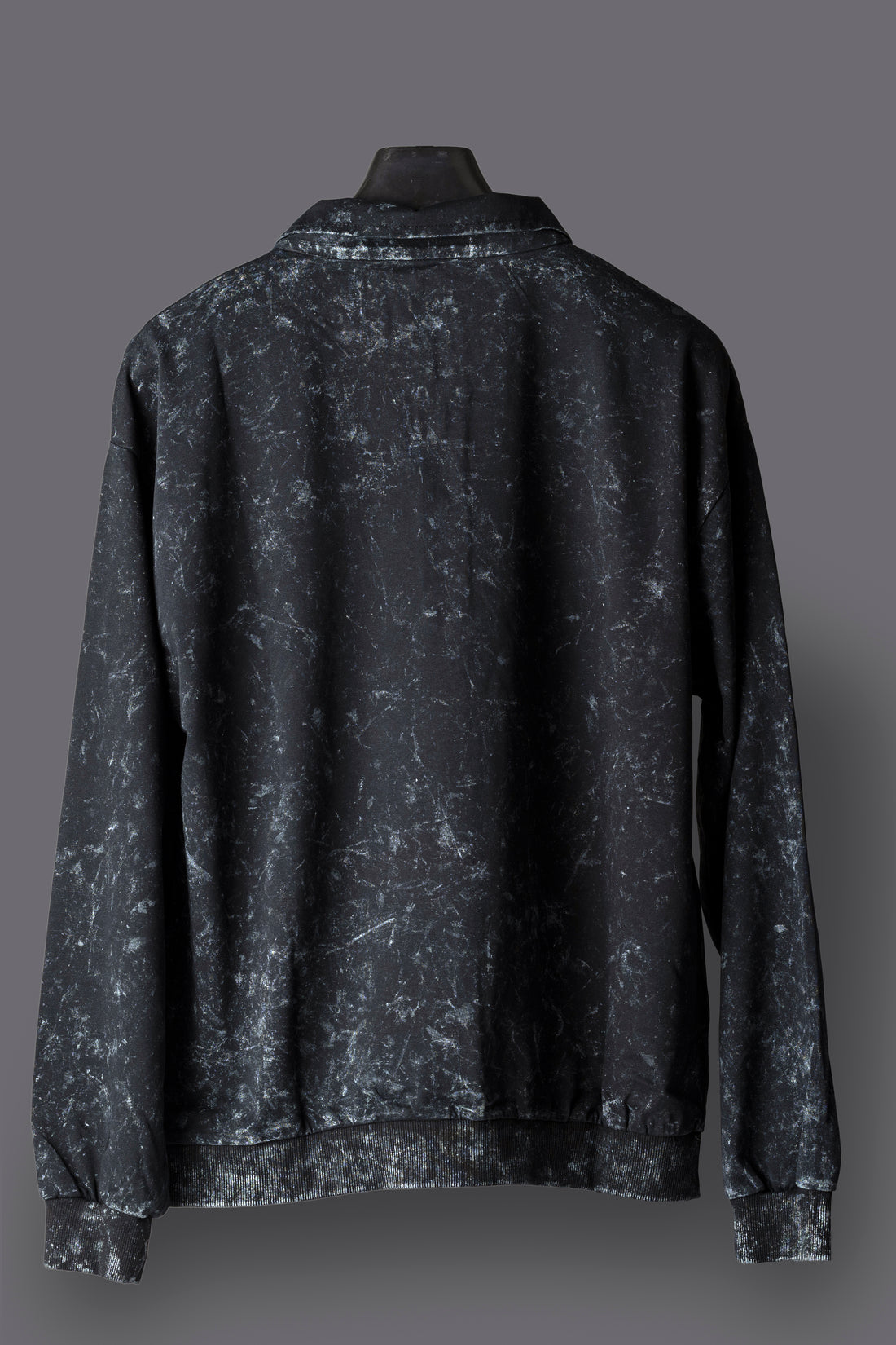 Black pullover with text on a gray background