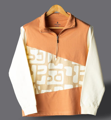 Orange and white pullover with geometric pattern on a gray background