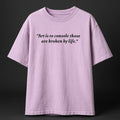 Purple t-shirt with a quote on a black background