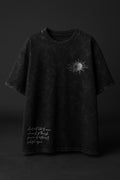 Black t-shirt with a small graphic on a dark background