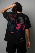 Person wearing a black t-shirt with 'Travis Scott' branding and text on the back against a gray background