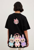 Person wearing a black t-shirt with colorful cartoon characters on the back