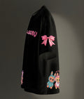 Black sweatshirt with pink bow and cartoon characters on a dark background