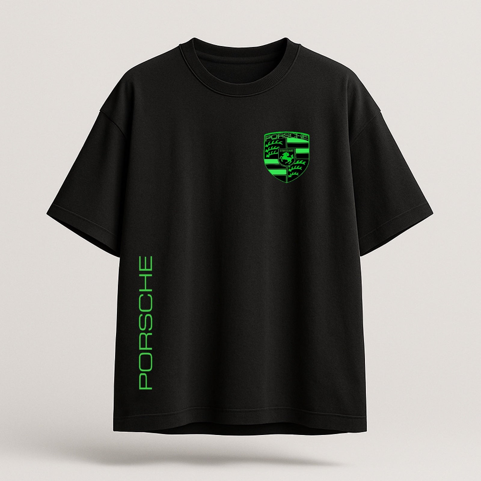 Black t-shirt with green Porsche logo and text on a light gray background
