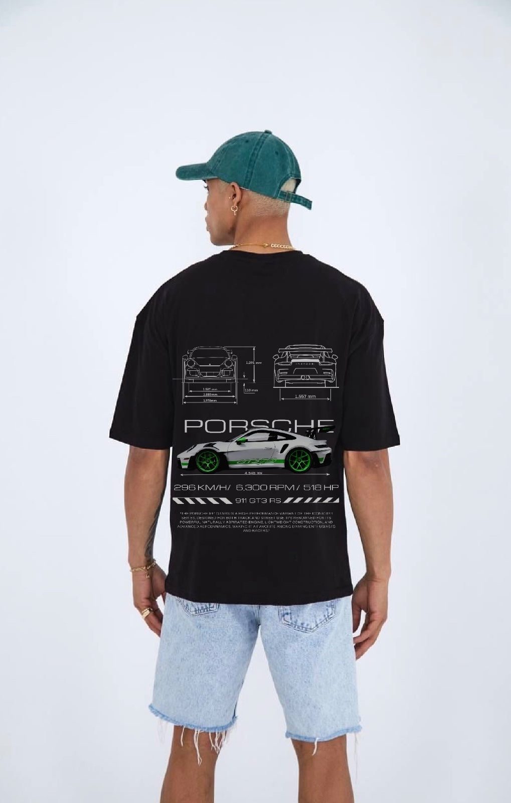 Person wearing a black t-shirt with Porsche car design on the back, standing against a white background