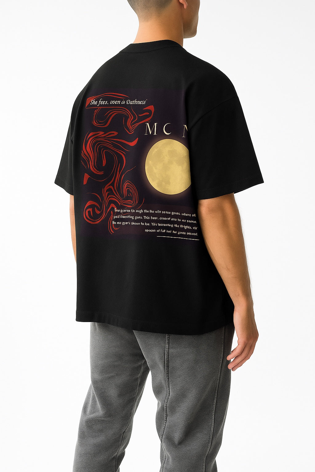 Person wearing a black t-shirt with a red dragon and moon design on the back, standing against a white background.