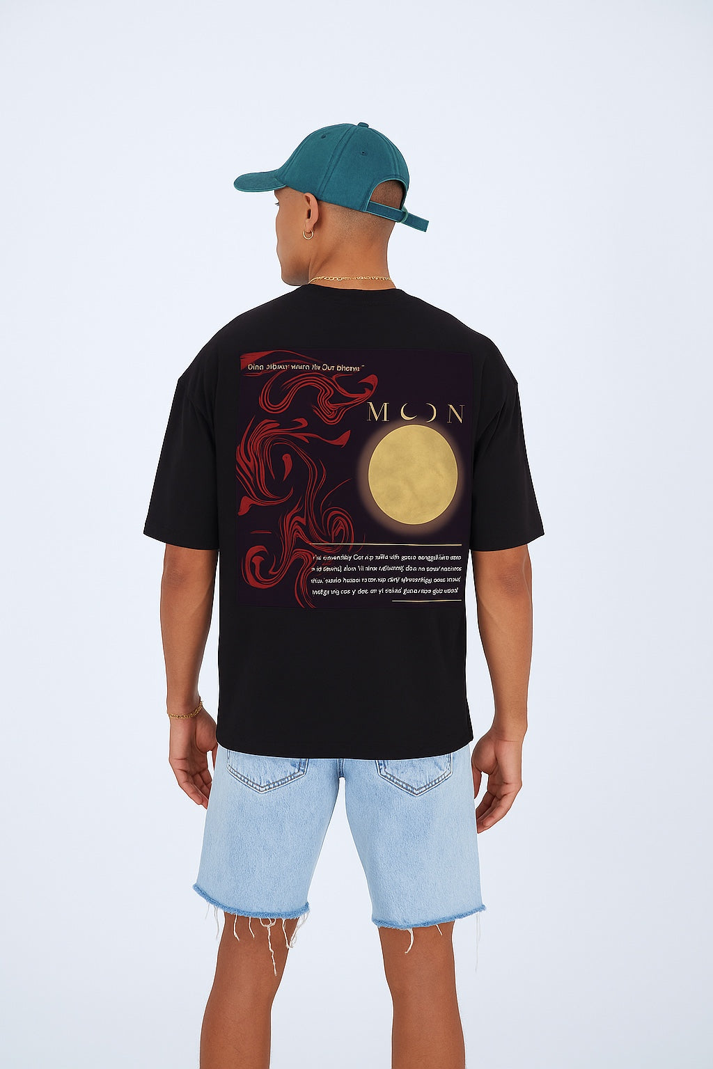 Person wearing a black t-shirt with red and gold design on the back, standing against a white background