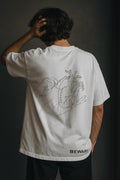 Person wearing a white t-shirt with a design on the back against a dark background