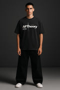 Person wearing a black t-shirt with 'AFTheory' logo on a dark background