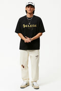Person wearing a black t-shirt with 'Selene' text, white pants, and a cap on a white background
